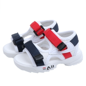 Vit sandal med flexibel sula och röda och svarta kardborreknäppningar