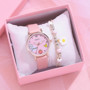 en rosa klocka och matchande armband i ett smyckeskrin